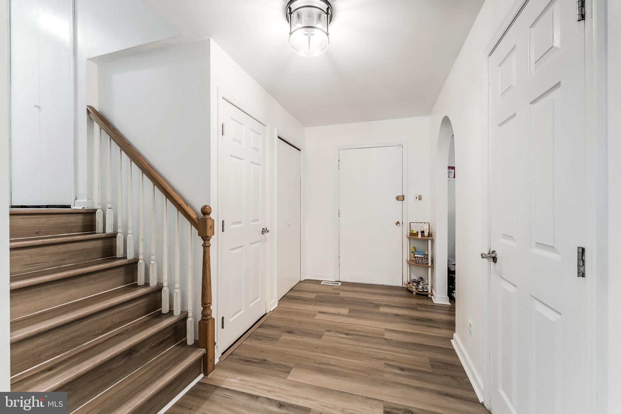 11621 Sourwood Lane Reston, VA 20191 - Photo 9 of 26 a view of a hallway with wooden floor and staircase