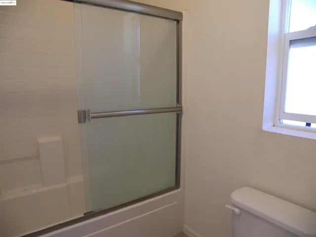 a bathroom with a shower and a toilet