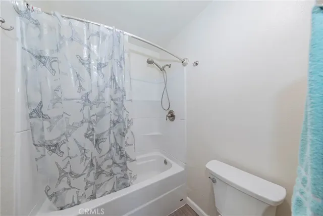 a bathroom with a toilet and shower