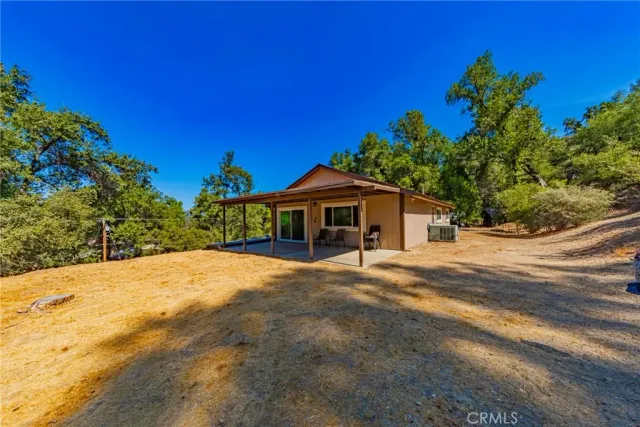 a yellow house with trees in front of it