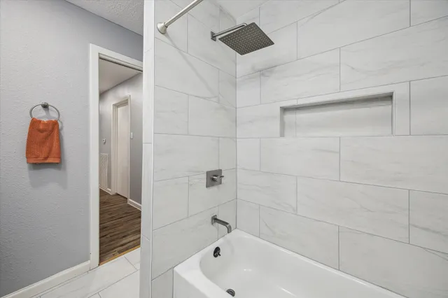 a bathroom with a bathtub and shower