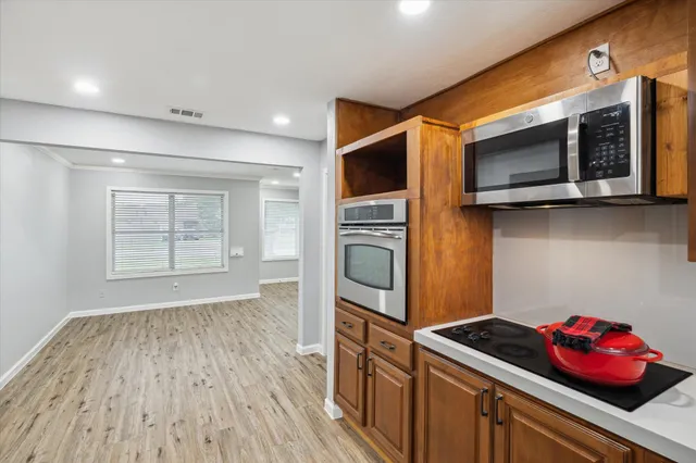 a kitchen with stainless steel appliances granite countertop a stove and a microwave