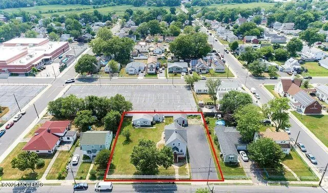 an aerial view of residential houses with outdoor space and street view