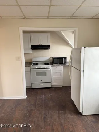 a kitchen with stainless steel appliances a refrigerator and a stove