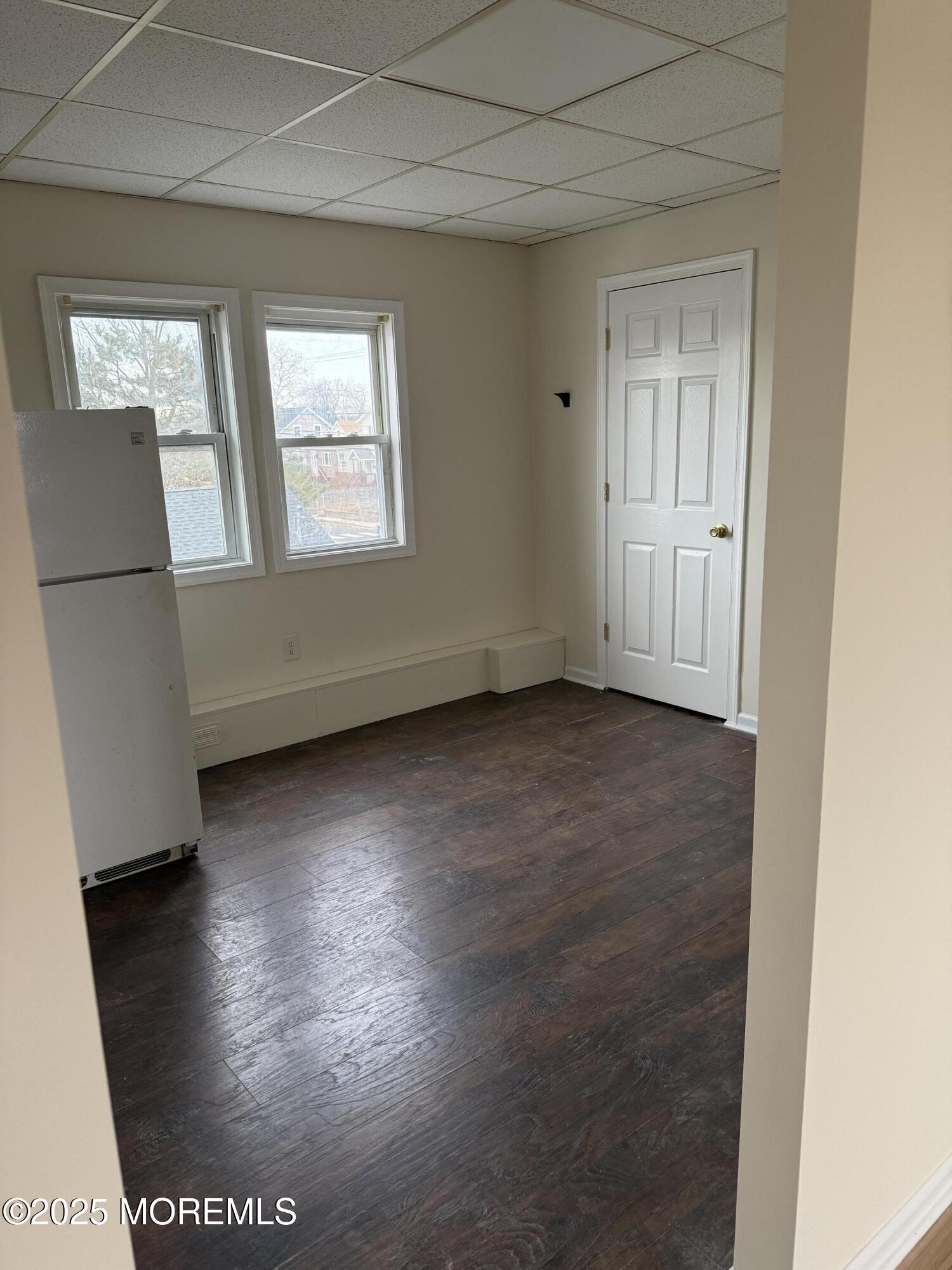 257 Carr Avenue, Unit B Keansburg, NJ 07734 - Photo 7 of 11 an empty room with wooden floor and windows