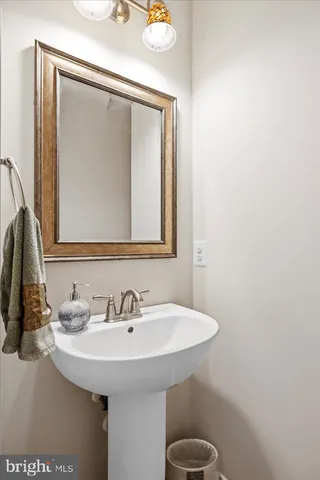 a bathroom with a tub sink and mirror