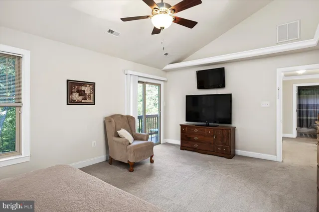 a balcony with wooden floor stairs and furniture