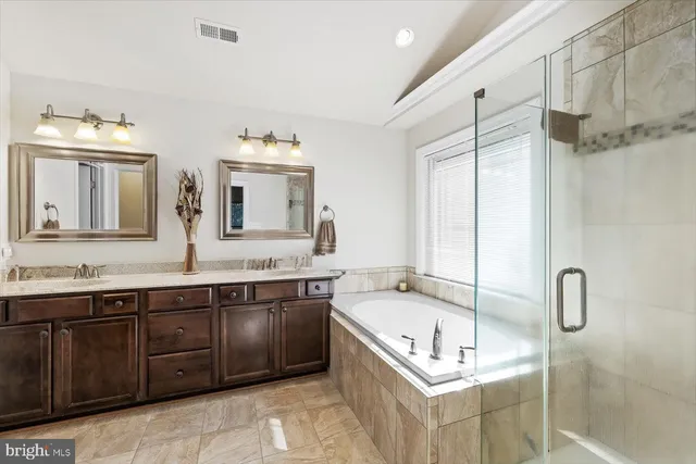 a bedroom with a bed and a potted plant