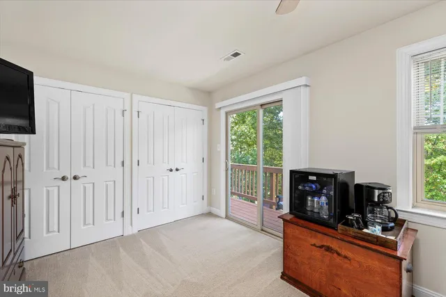 a living room with a fireplace a flat screen tv and a fireplace