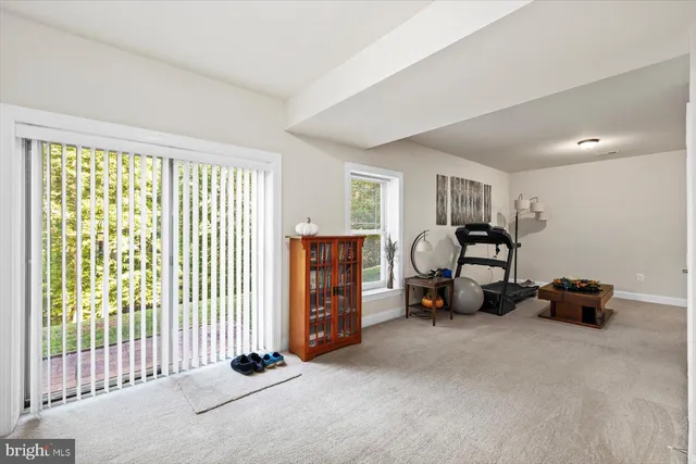 a view of a house with a yard and potted plants