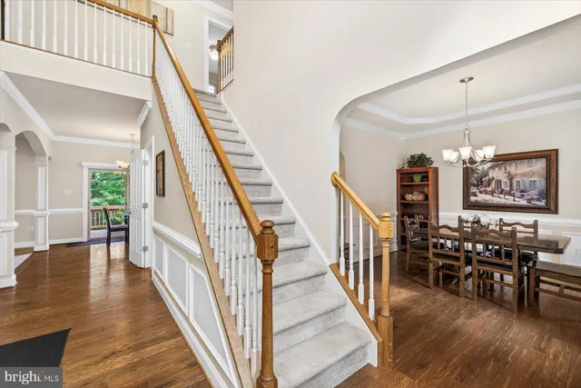 a kitchen with a dining table chairs stainless steel appliances and cabinets
