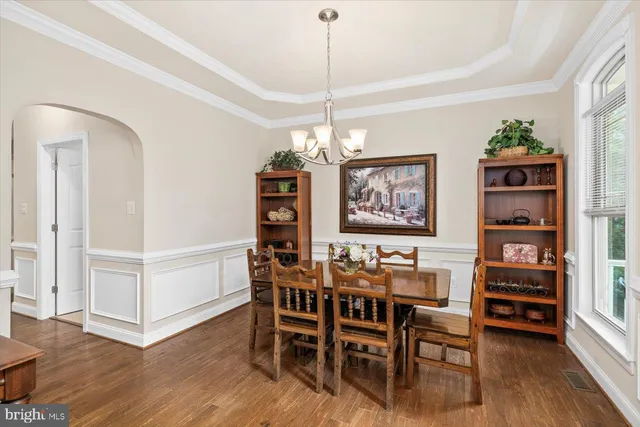 a kitchen with stainless steel appliances granite countertop white cabinets granite counter tops and a window