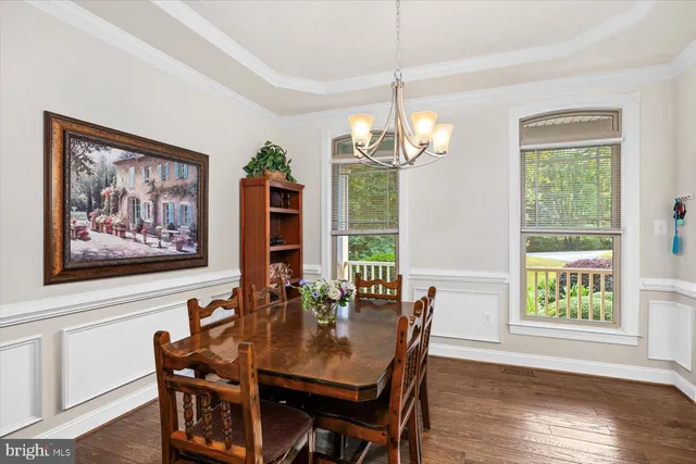 a kitchen with stainless steel appliances granite countertop white cabinets and a stove a oven with white countertops