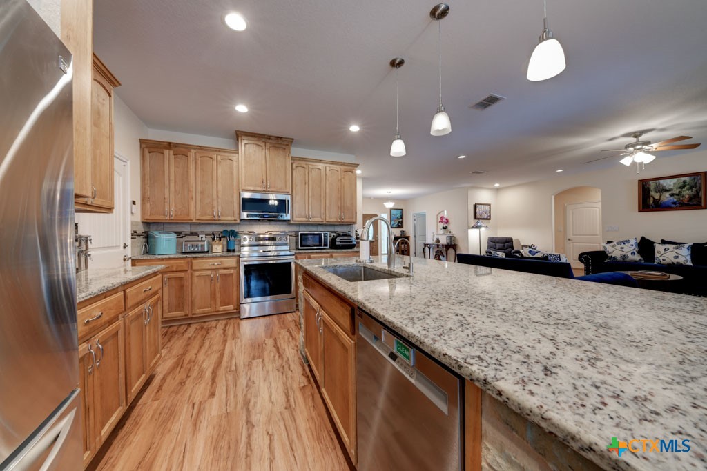 861 Rutherford Fischer, TX 78623 - Photo 12 of 38 Multiple custom cabinets and large kitchen island w/granite countertops.