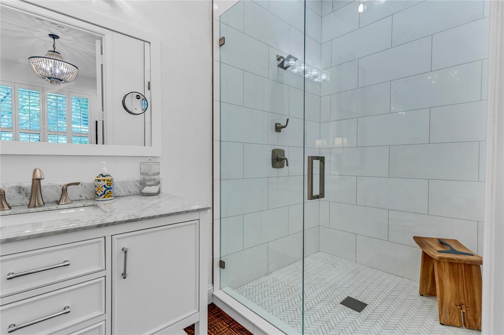 5744 Robbie Road Plano, TX 75024 - Photo 6 of 32 Modern bathroom featuring a glass-enclosed shower with subway tile surround and herringbone floor tile