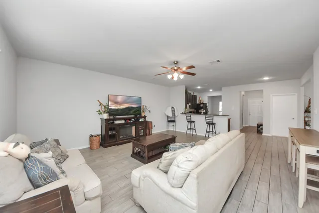 a living room with furniture and a chandelier