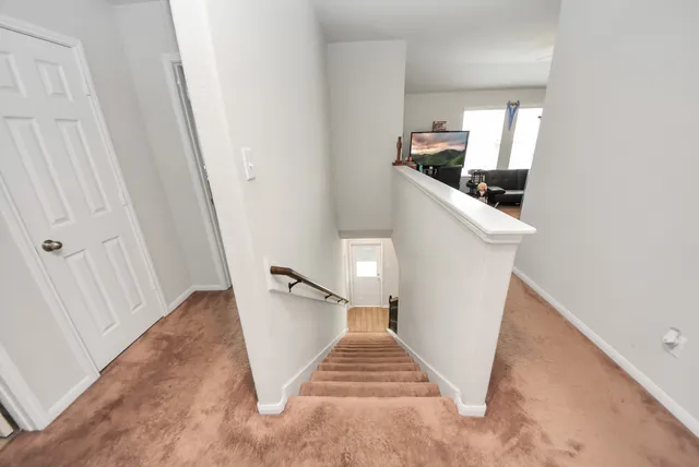 a view of a hallway view with staircase