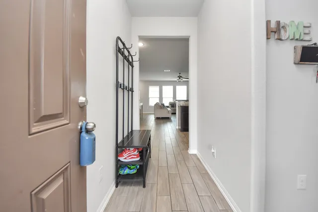 a view of a hallway view with wooden floor and staircase