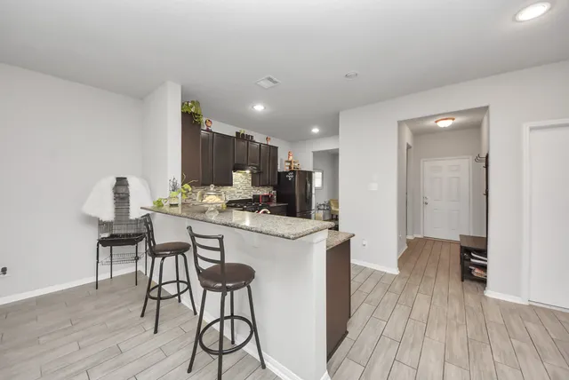 a kitchen with a table and chairs in it