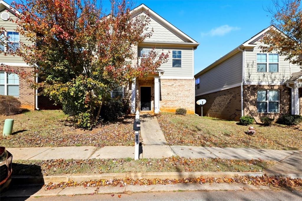 a front view of a house with a yard