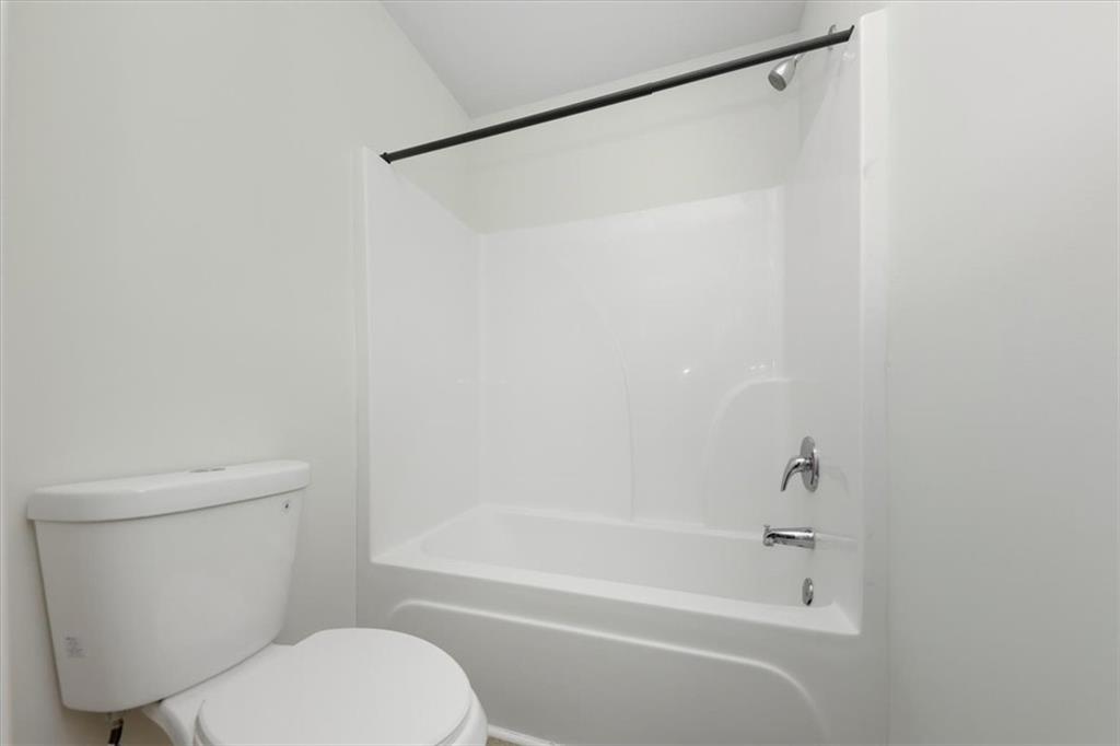 541 Tulip Lane McDonough, GA 30252 - Photo 19 of 32 a white toilet and shower sitting next to a white sink