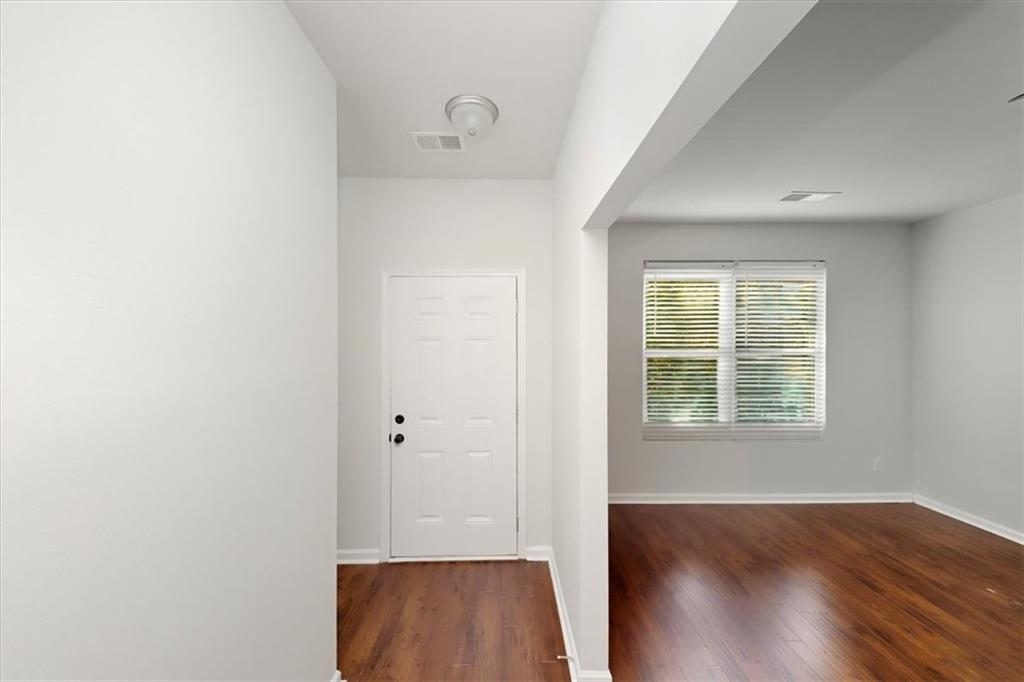 541 Tulip Lane McDonough, GA 30252 - Photo 2 of 32 an empty room with wooden floor and windows