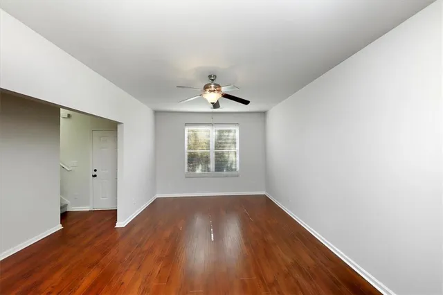 wooden floor in an empty room with a window