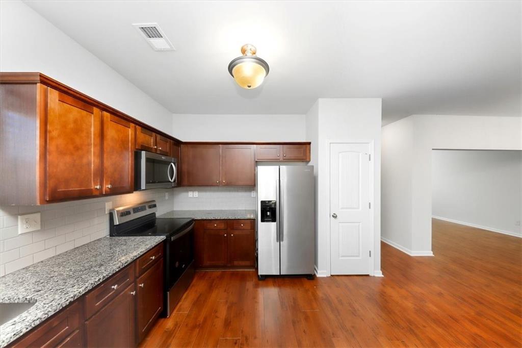541 Tulip Lane McDonough, GA 30252 - Photo 7 of 32 a kitchen with a sink and a refrigerator