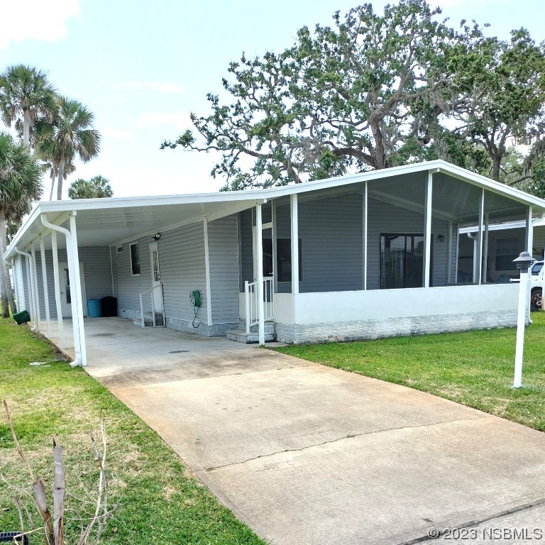 168 Red Bass Lane Edgewater, FL 32141 - Photo 13 of 14 a view of a house with a yard and large tree
