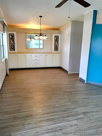 a view of a kitchen with microwave and cabinets
