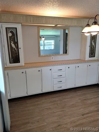 a view of a kitchen with cabinet and mirror