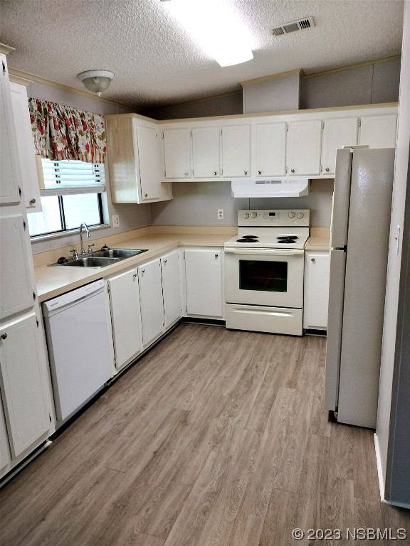 168 Red Bass Lane Edgewater, FL 32141 - Photo 6 of 14 a kitchen with granite countertop white cabinets and white appliances