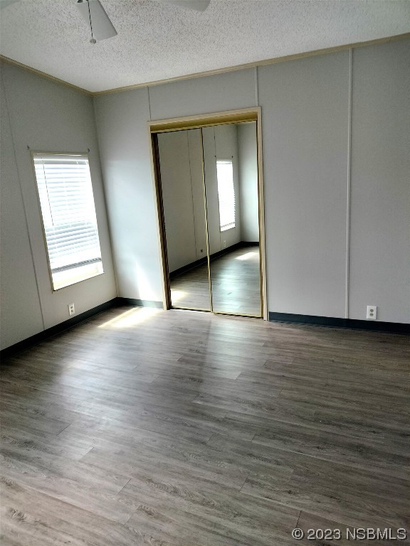 168 Red Bass Lane Edgewater, FL 32141 - Photo 8 of 14 an empty room with wooden floor and windows