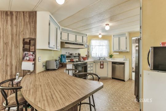 1975 East Burns Avenue Ridgecrest, CA 93555 - Photo 10 of 43 a kitchen with a sink a counter space appliances and cabinets