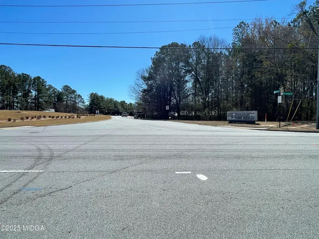 a view of white house with a yard