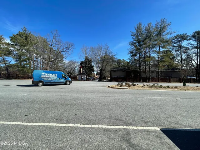 a view of street with large trees