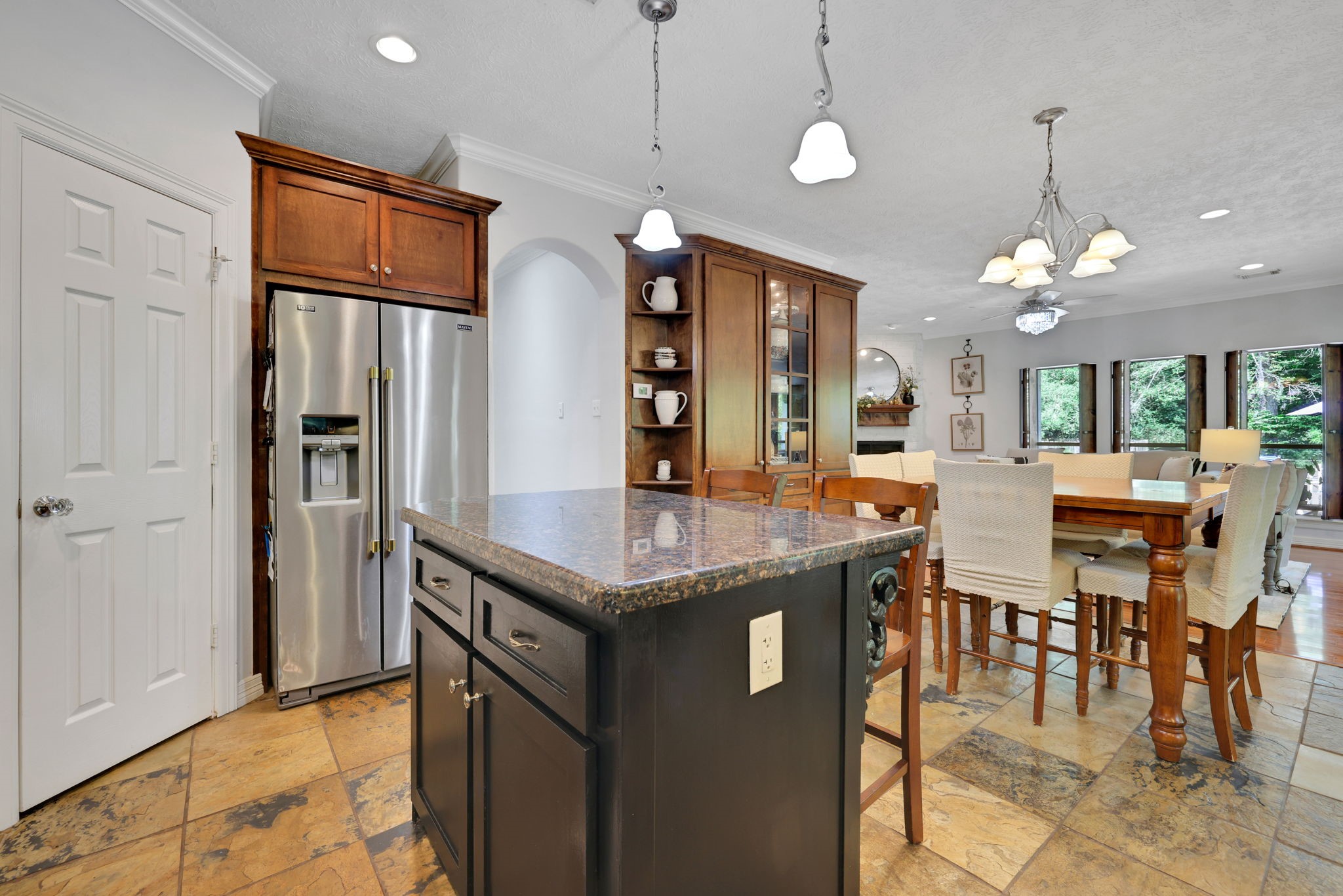 991 Kings Way Coldspring, TX 77331 - Photo 15 of 49 a kitchen with stainless steel appliances granite countertop a kitchen island a stove and a refrigerator