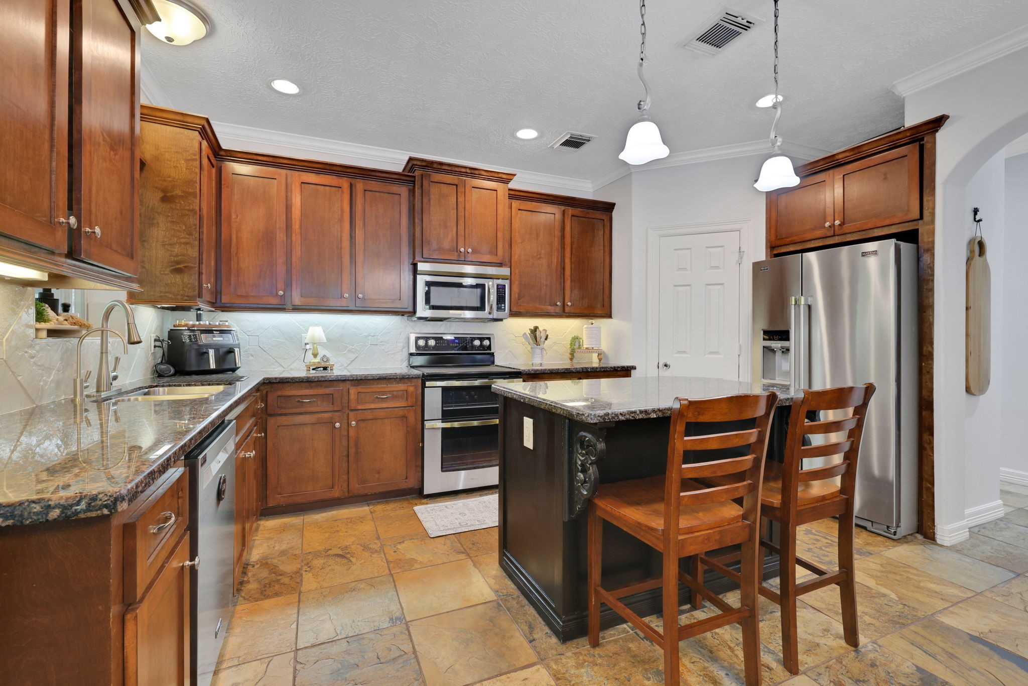 991 Kings Way Coldspring, TX 77331 - Photo 16 of 49 a kitchen with granite countertop a sink appliances and cabinets