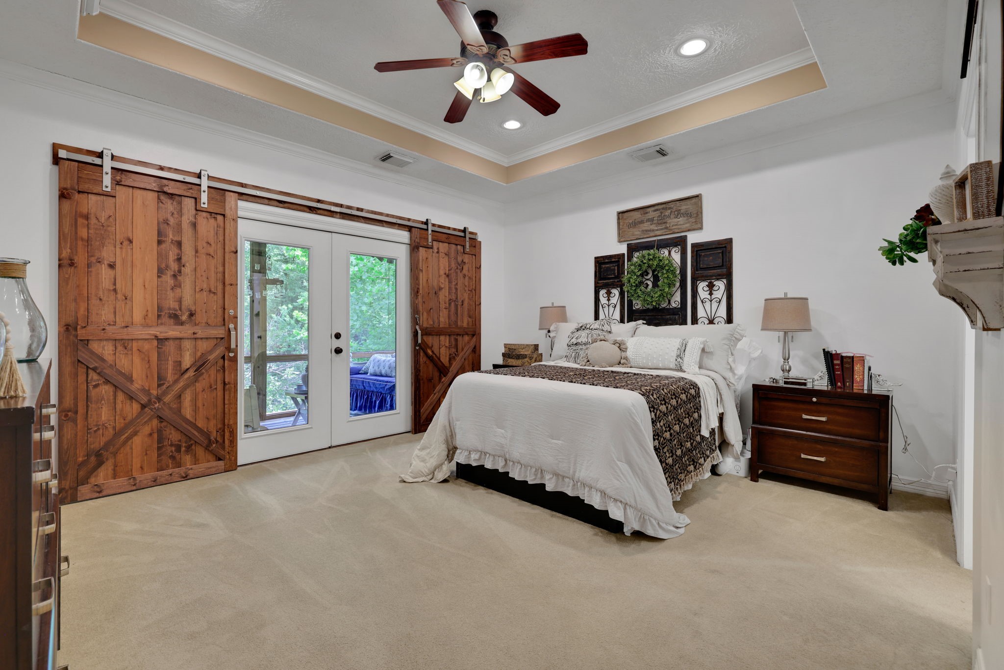 991 Kings Way Coldspring, TX 77331 - Photo 19 of 49 a spacious bedroom with a large bed and a chandelier