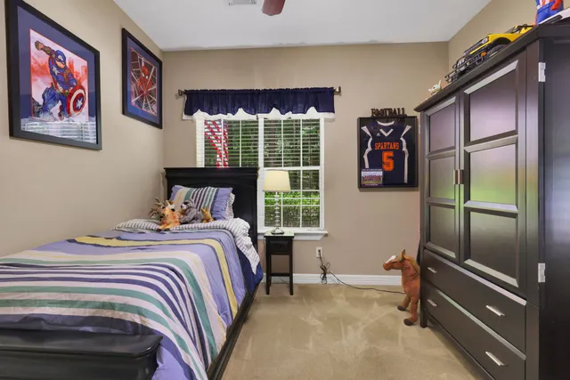 a bedroom with a bed and a window