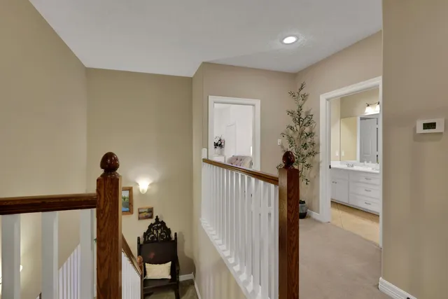 a view of a hallway to a livingroom with furniture
