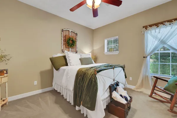 a bedroom with a bed and a chandelier