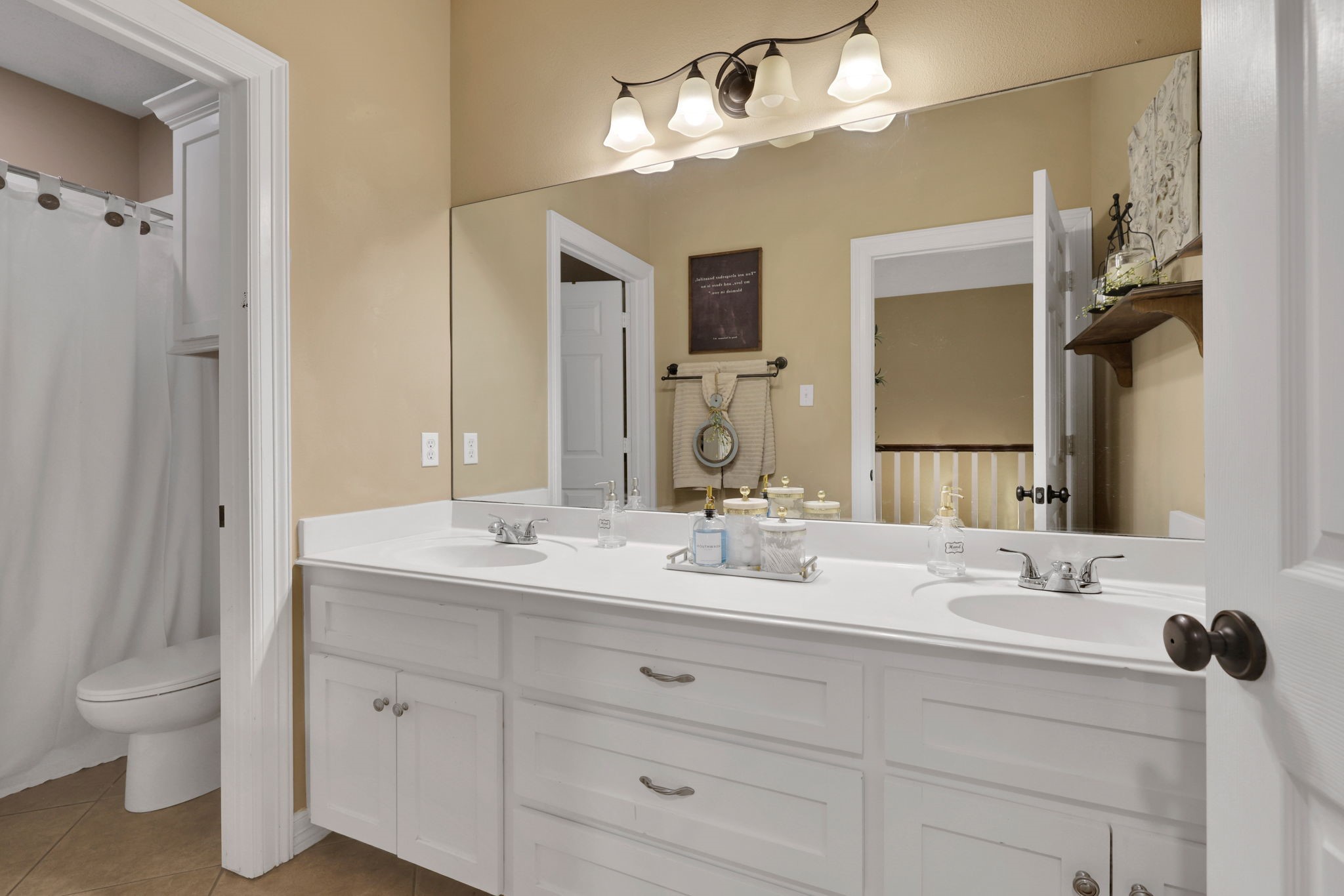 991 Kings Way Coldspring, TX 77331 - Photo 31 of 49 a bathroom with a double vanity sink and a mirror