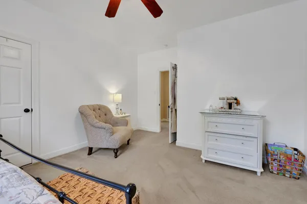 a living room with furniture and a baby crib