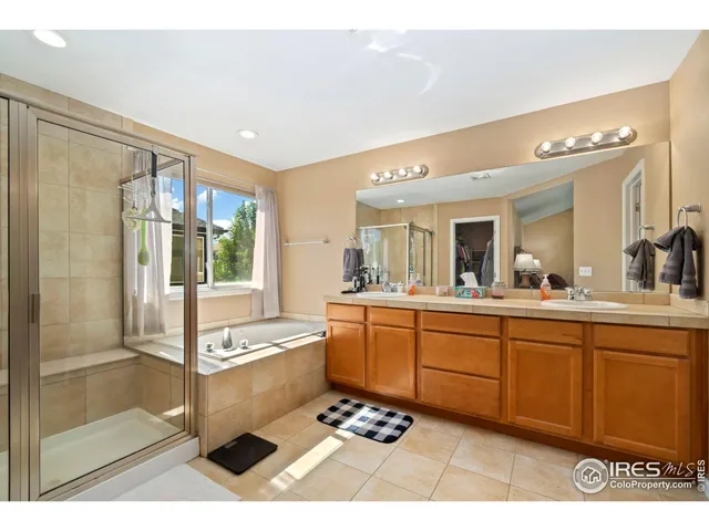 a spacious bathroom with a tub shower and sink