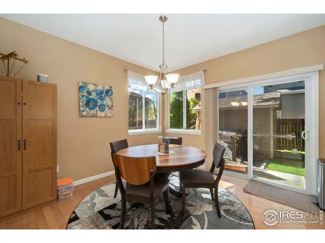 a dining room with furniture a chandelier and window