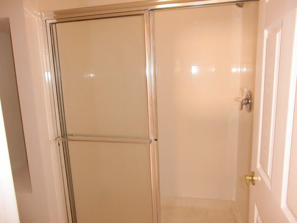 2691 Southwest 99th Way, Unit 2691 Miramar, FL 33025 - Photo 15 of 17 a bathroom with a glass shower door