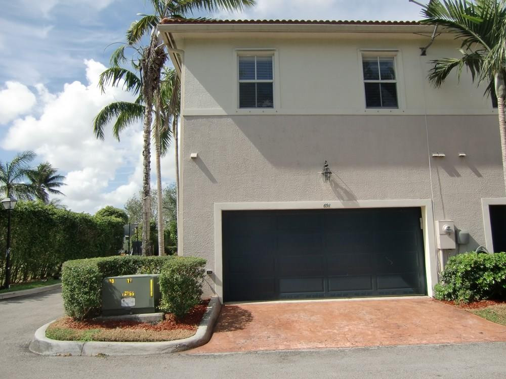 2691 Southwest 99th Way, Unit 2691 Miramar, FL 33025 - Photo 2 of 17 a view of a house with a yard and potted plants
