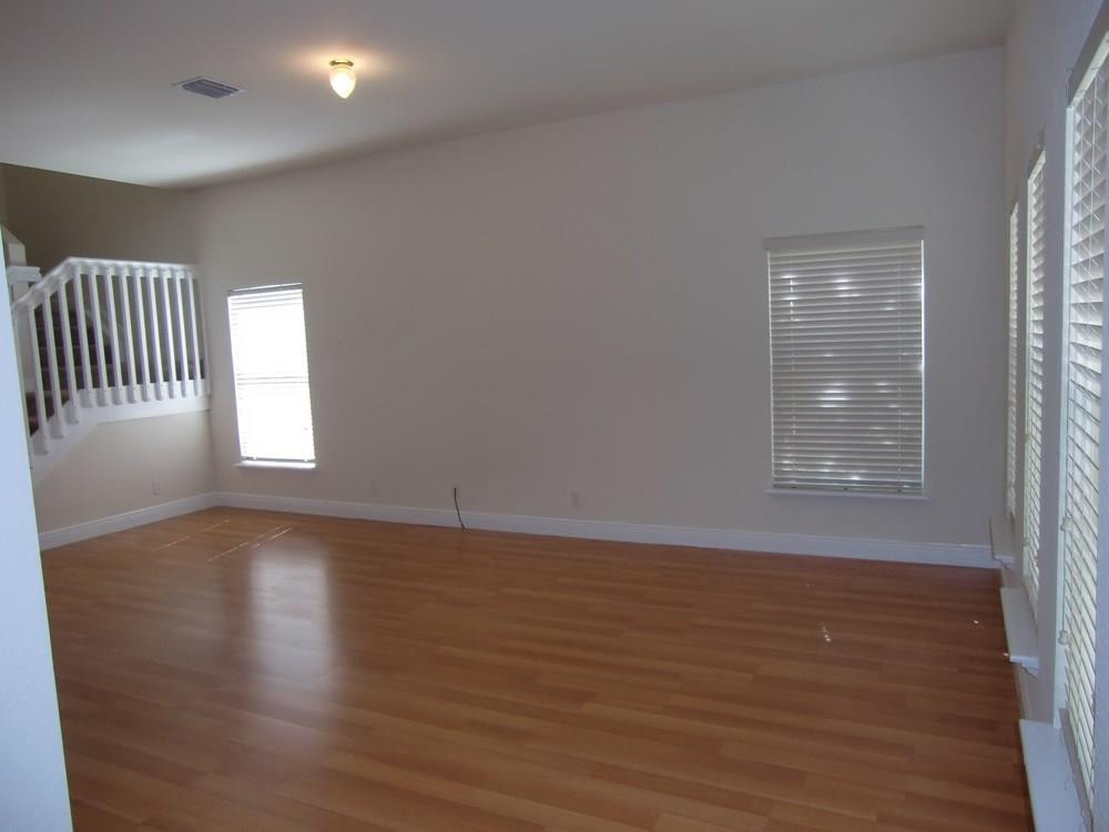 2691 Southwest 99th Way, Unit 2691 Miramar, FL 33025 - Photo 3 of 17 a view of an empty room with wooden floor and a window