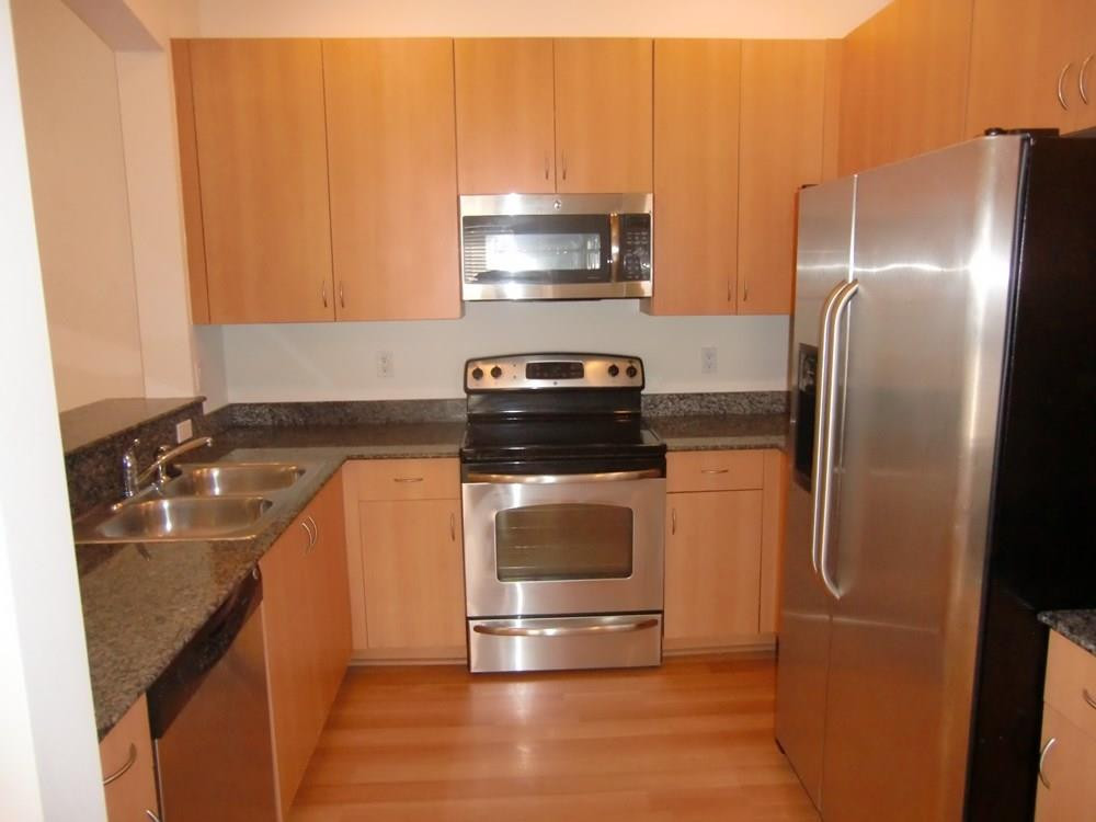 2691 Southwest 99th Way, Unit 2691 Miramar, FL 33025 - Photo 5 of 17 a kitchen with a refrigerator and a stove